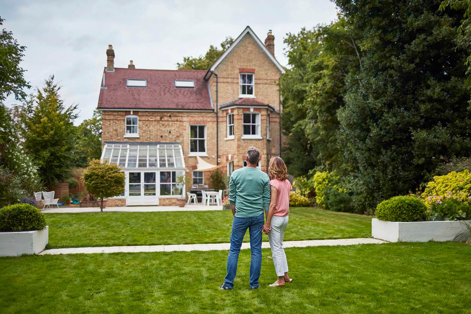 homeowners looking up at house