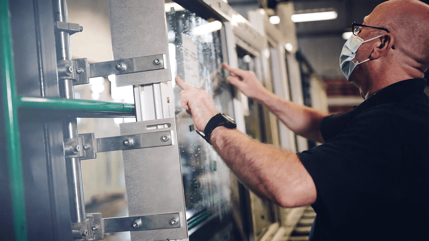 staff fitting glass into window frame
